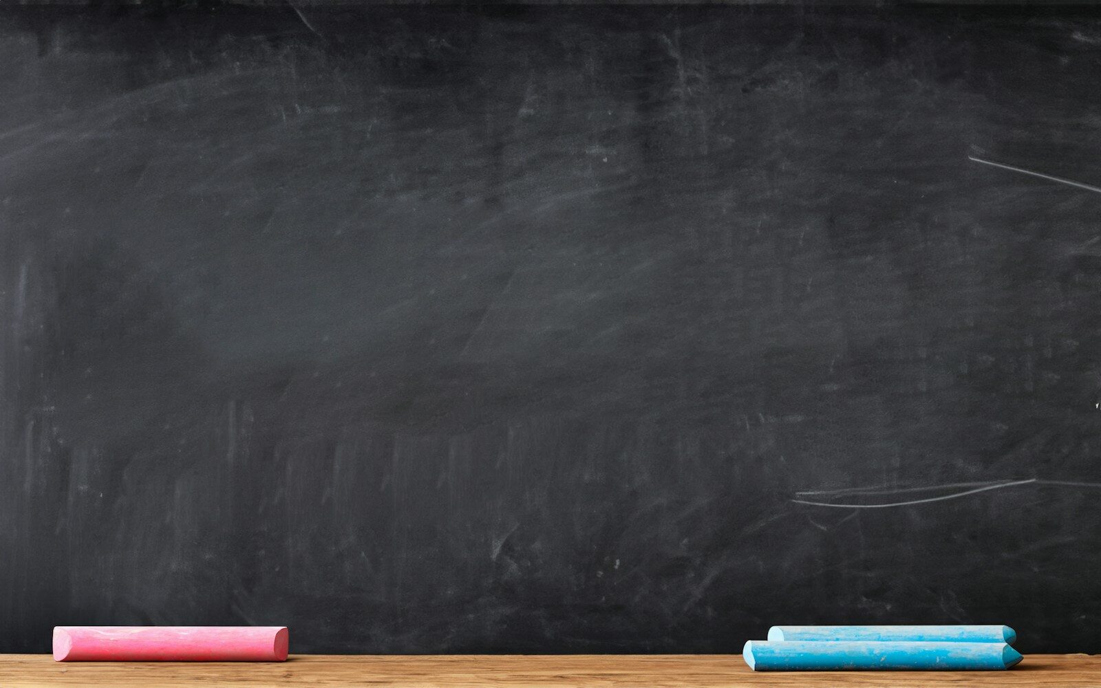 a blackboard with a chalkboard and some colored pencils